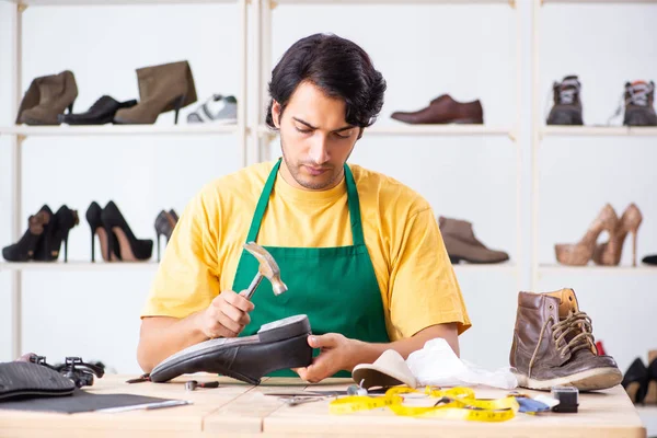 depositphotos 243986942 stock photo young man repairing shoes in